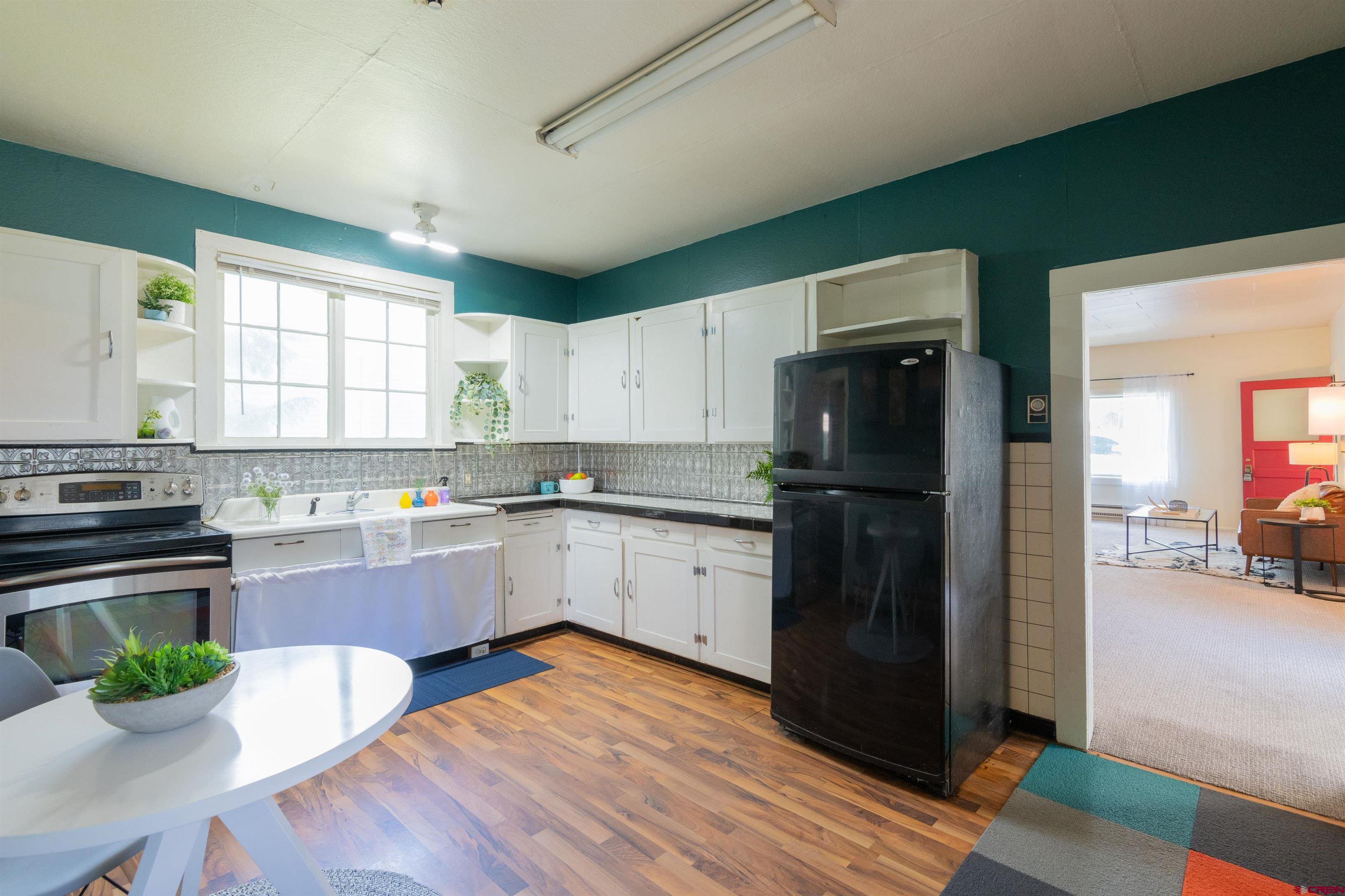 322 Maroon Avenue Crested Butte, CO 81224 - Photo 8 of 24 a kitchen with a refrigerator and a stove top oven