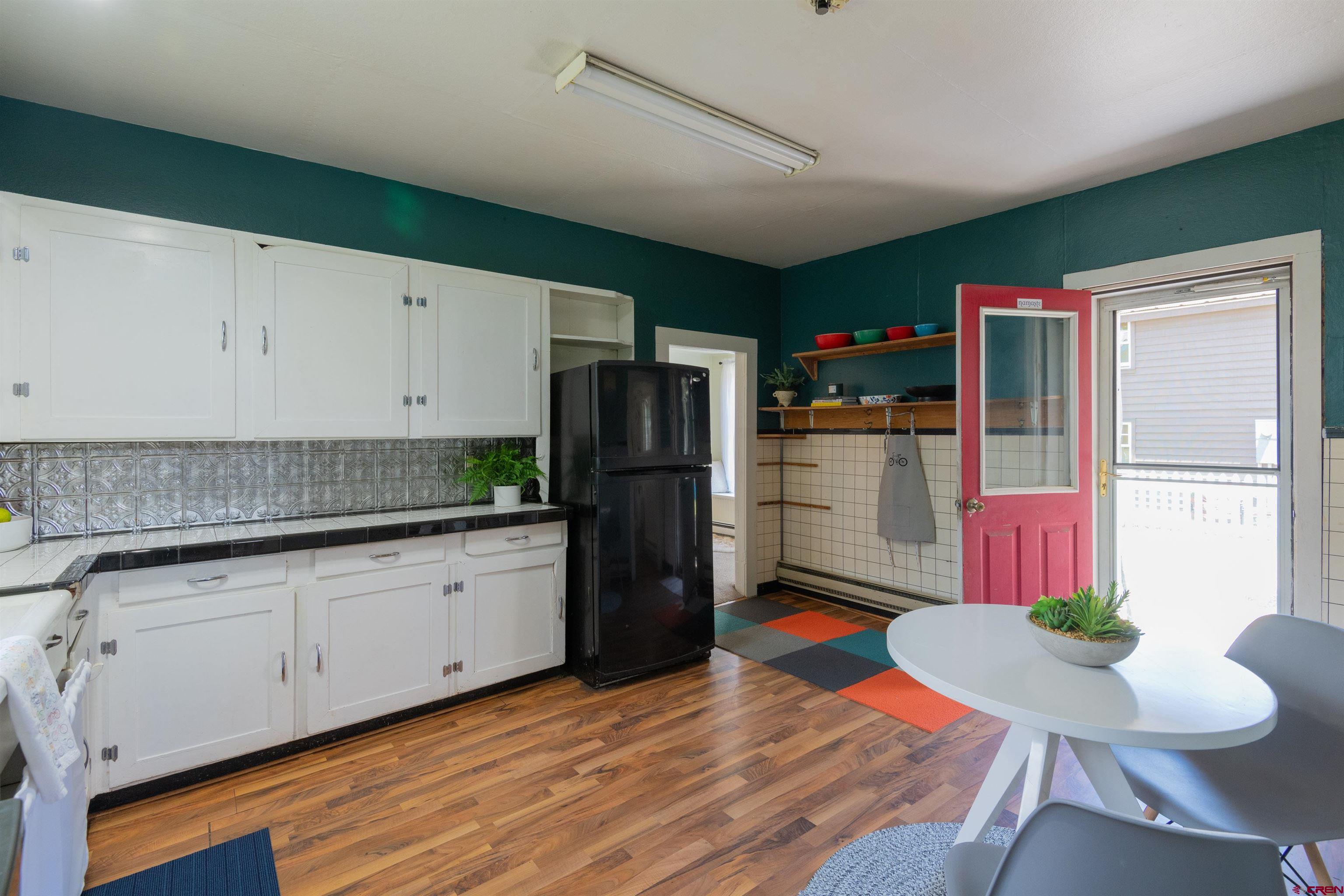 322 Maroon Avenue Crested Butte, CO 81224 - Photo 9 of 24 a kitchen with granite countertop kitchen island stainless steel appliances a refrigerator microwave and cabinets