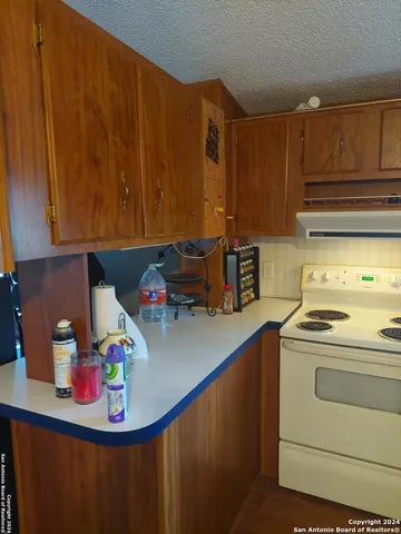 a kitchen with stainless steel appliances wooden cabinets sink and stove