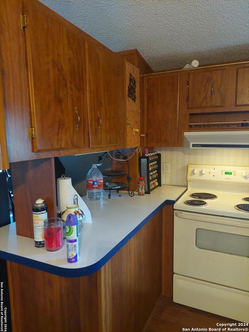 22159 Pr 1080 Mathis, TX 78368 - Photo 6 of 15 a kitchen with stainless steel appliances wooden cabinets sink and stove