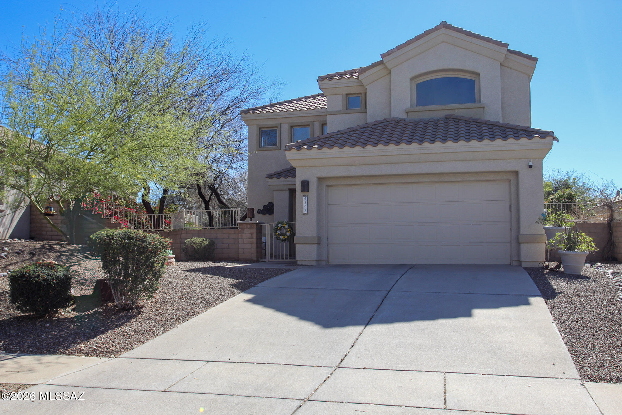5202 Spring View Drive Tucson, AZ 85749 - Photo 5 of 49 a front view of a house with a yard
