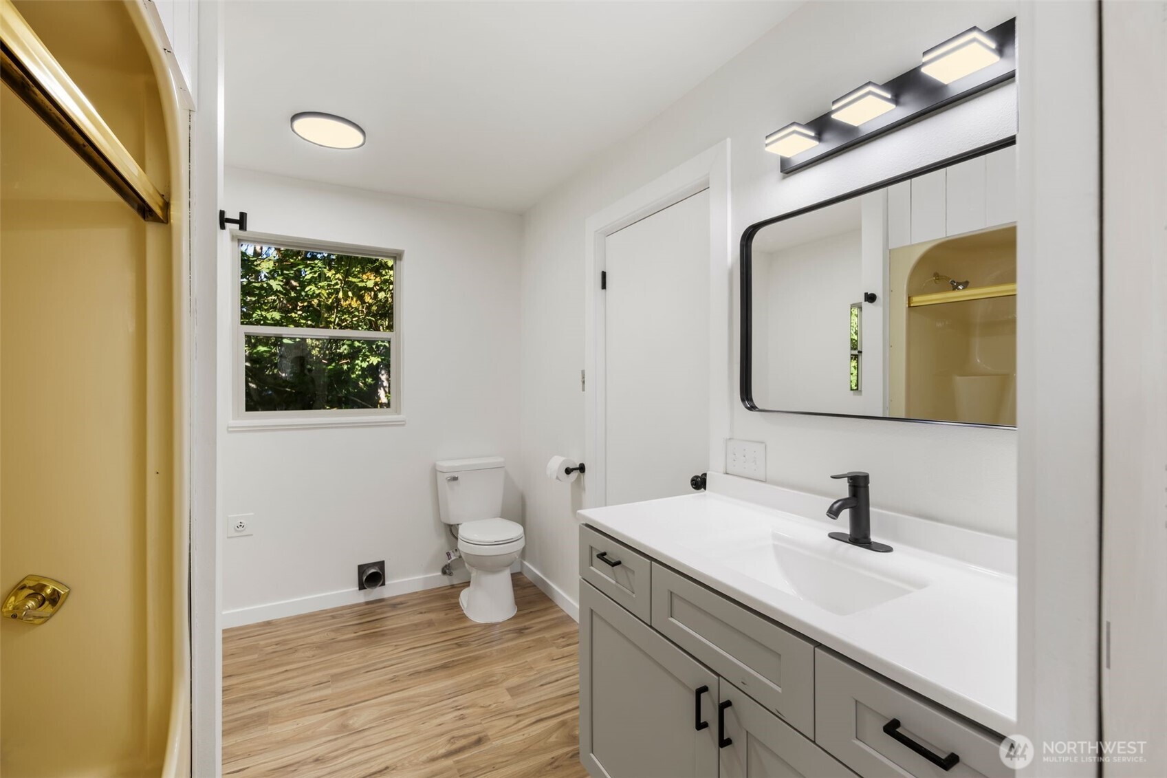 5502 Northeast 10th Street Renton, WA 98059 - Photo 17 of 27 a bathroom with a sink a toilet and a mirror