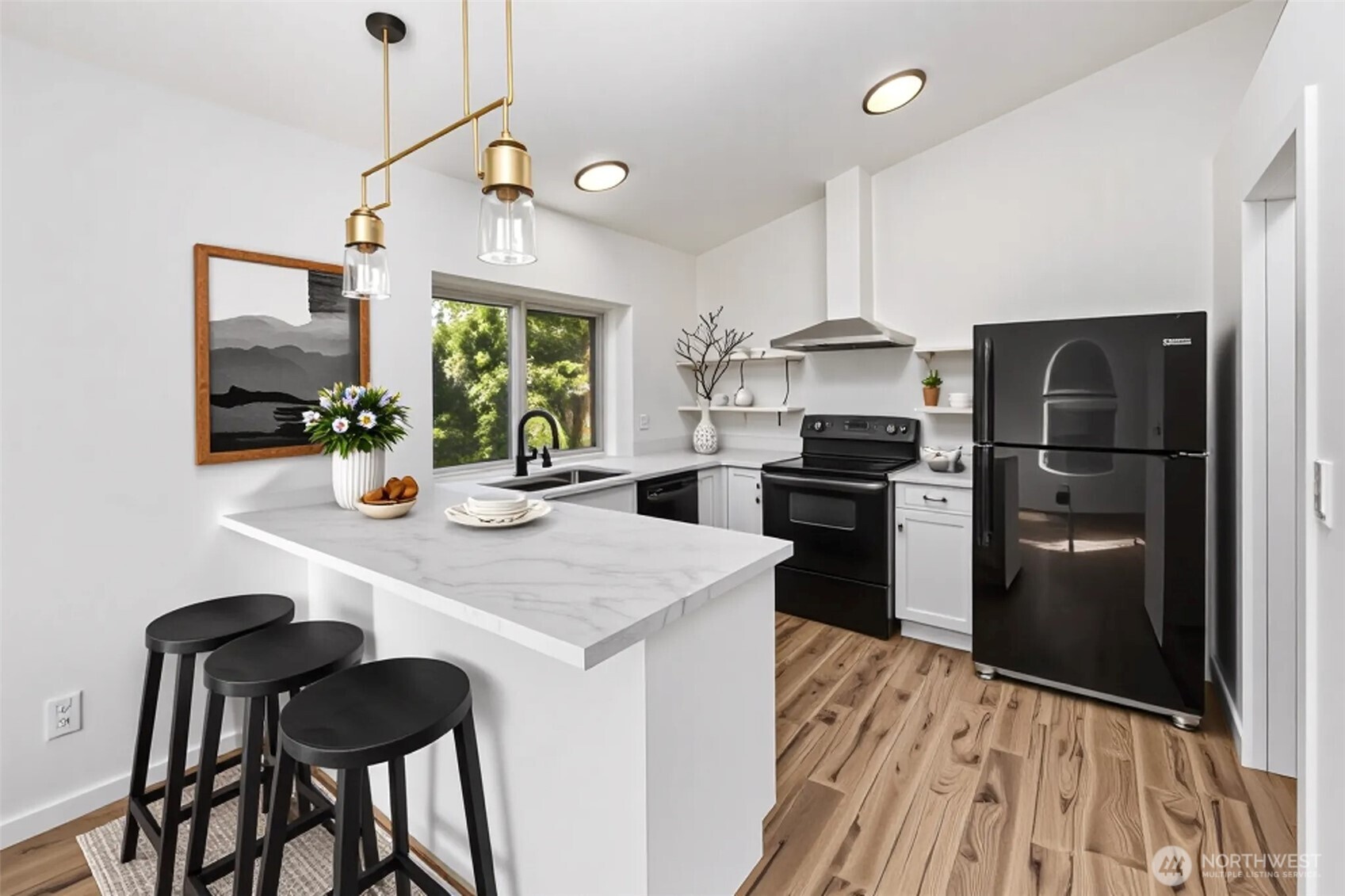 5502 Northeast 10th Street Renton, WA 98059 - Photo 6 of 27 a kitchen with a refrigerator a stove and a dining table with wooden floor