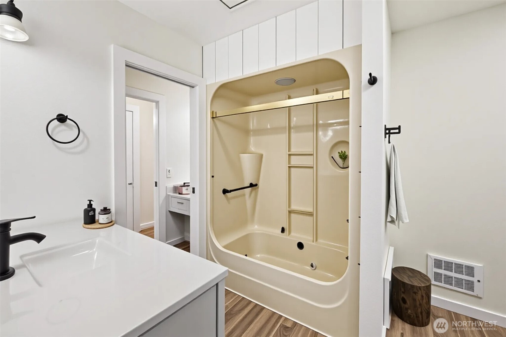 5502 Northeast 10th Street Renton, WA 98059 - Photo 10 of 27 a bathroom with a tub a sink and a mirror
