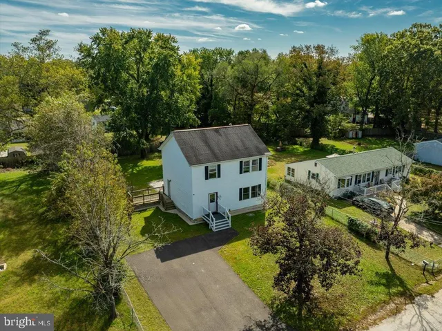an aerial view of a house with a big yard
