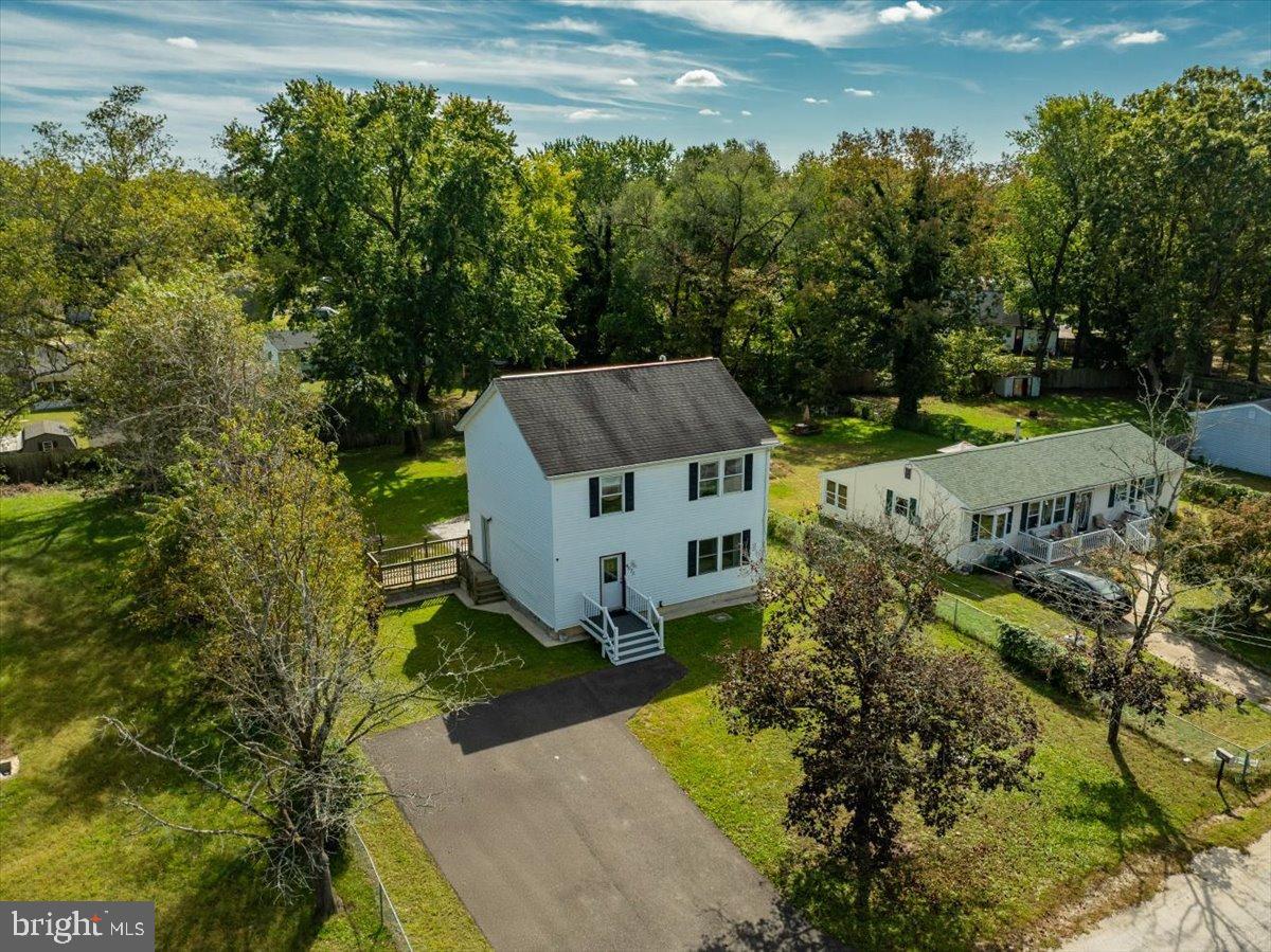 an aerial view of a house with a big yard