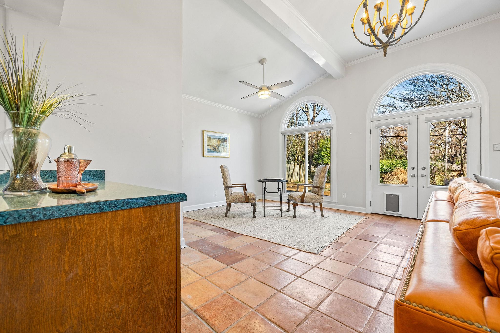 1002 Kings Park Road Memphis, TN 38117 - Photo 20 of 40 a living room with furniture a chandelier and a dining table