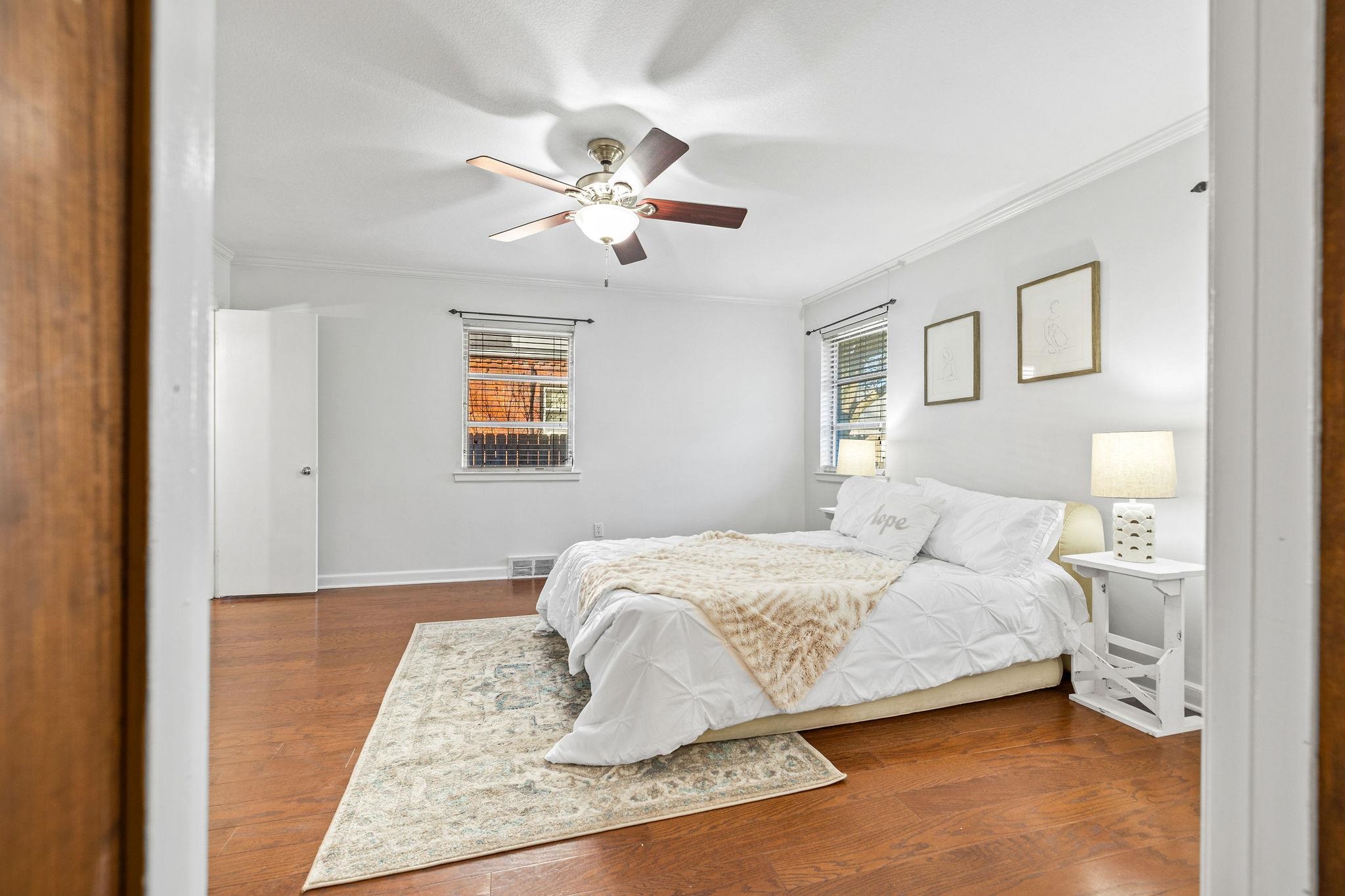 1002 Kings Park Road Memphis, TN 38117 - Photo 25 of 40 a bedroom with a bed and a chandelier