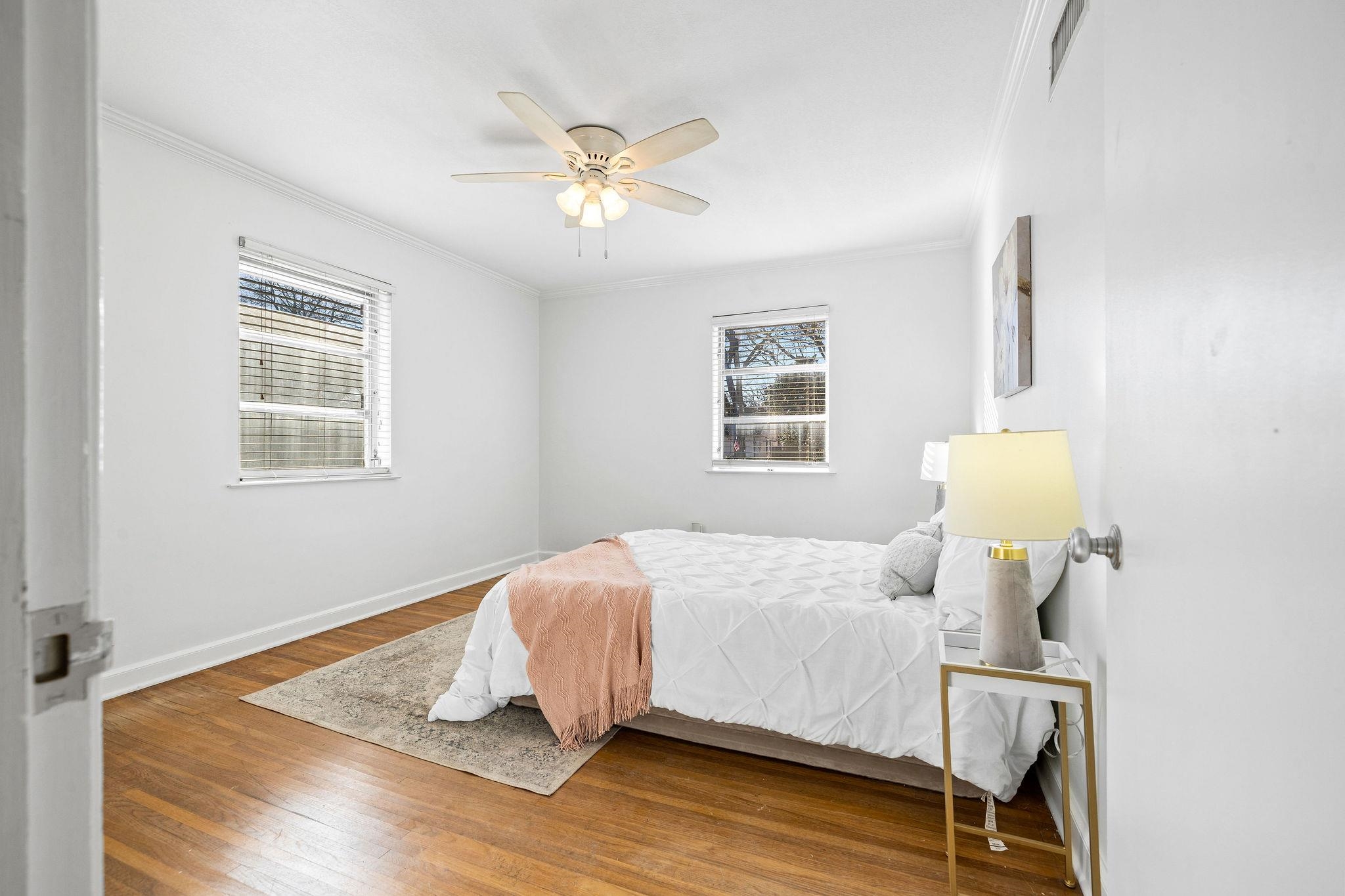 1002 Kings Park Road Memphis, TN 38117 - Photo 33 of 40 a bedroom with a bed and wooden floor