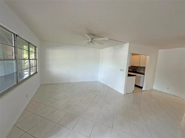 a view of a kitchen with an empty space and a window