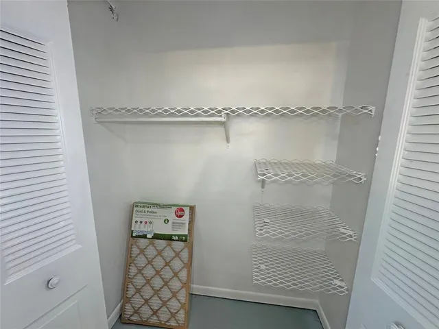 a bathroom with a toilet sink vanity and mirror