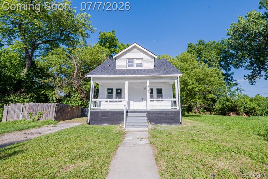 18486 Trinity Street Detroit, MI 48219 - Photo 1 of 19 White siding exterior with a dark shingled roof and dormer window