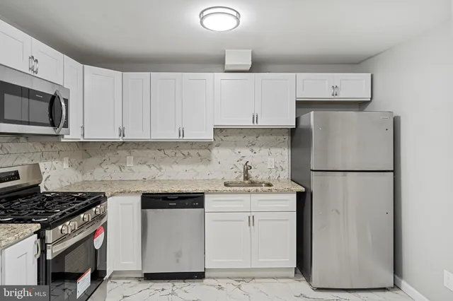 a kitchen with a white stove top oven and refrigerator