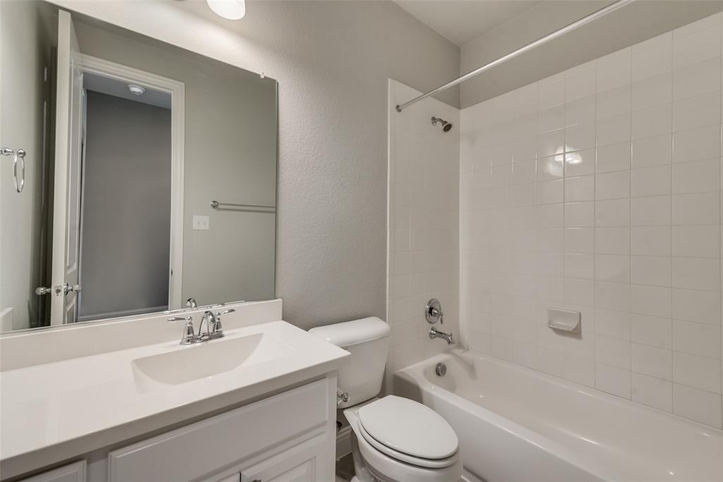 3916 Ironbark Way McKinney, TX 75071 - Photo 11 of 23 a bathroom with a toilet a sink and a bathtub