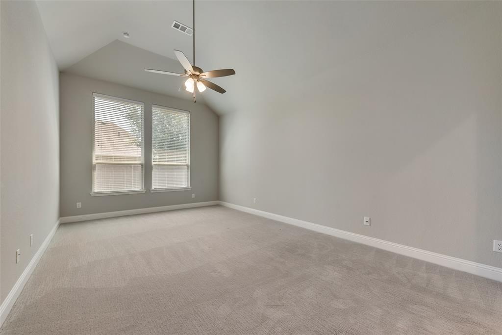 3916 Ironbark Way McKinney, TX 75071 - Photo 17 of 23 en empty room with windows and ceiling fan