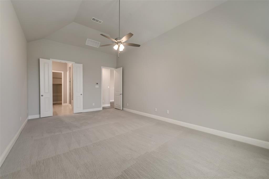3916 Ironbark Way McKinney, TX 75071 - Photo 18 of 23 an empty room with a window and ceiling fan