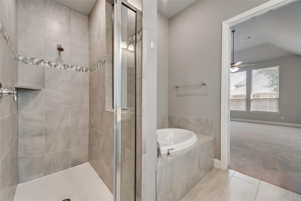 3916 Ironbark Way McKinney, TX 75071 - Photo 20 of 23 a bathroom with a tub and shower