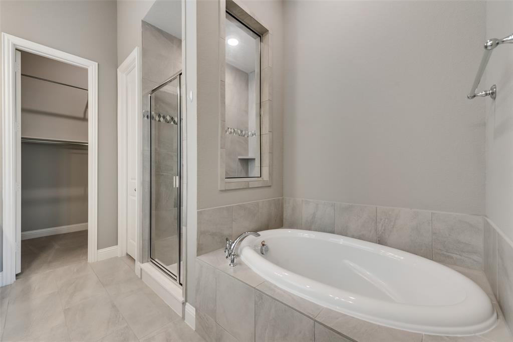 3916 Ironbark Way McKinney, TX 75071 - Photo 21 of 23 a white bath tub sitting next to a shower