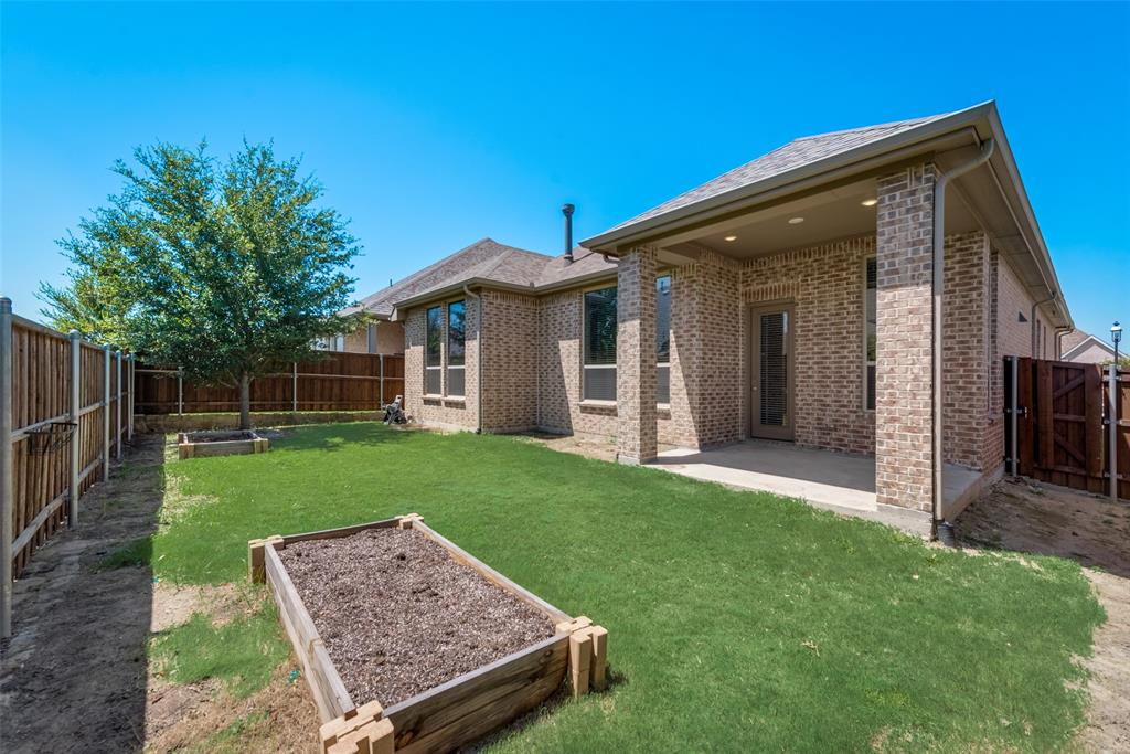 3916 Ironbark Way McKinney, TX 75071 - Photo 23 of 23 a view of a backyard with a garden and plants