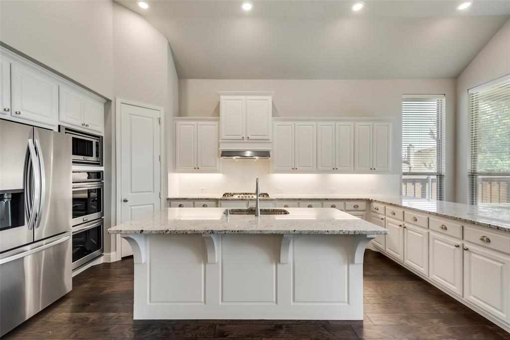 3916 Ironbark Way McKinney, TX 75071 - Photo 9 of 23 a kitchen with stainless steel appliances granite countertop a sink and cabinets