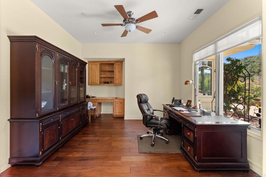 28820 Willow Park Road Escondido, CA 92026 - Photo 11 of 72 a living room with furniture a flat screen tv and a floor to ceiling window