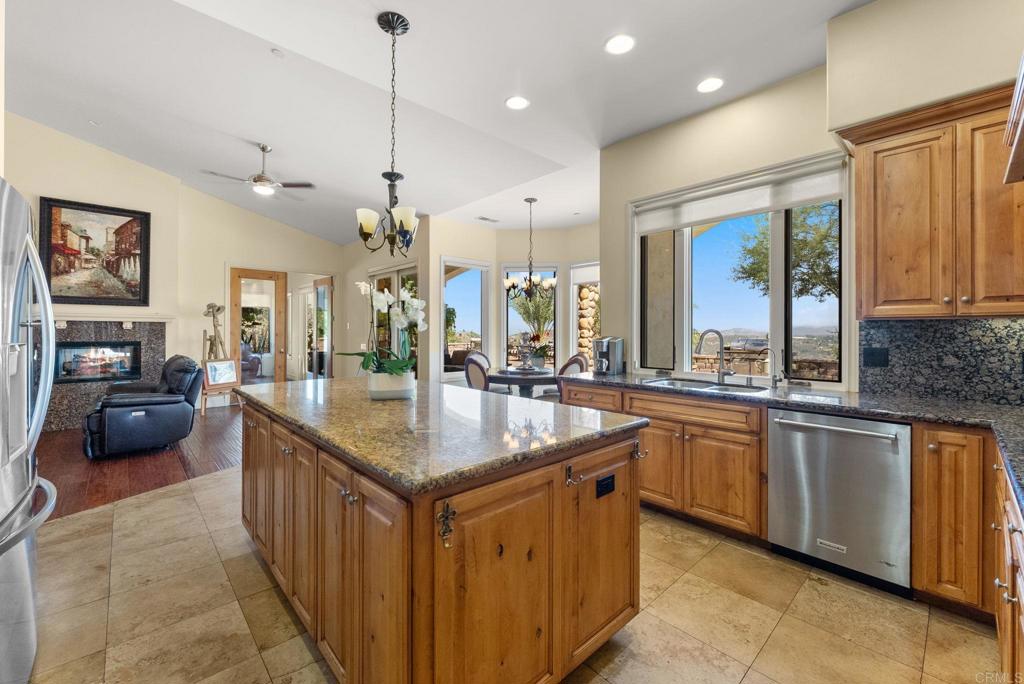28820 Willow Park Road Escondido, CA 92026 - Photo 12 of 72 a kitchen with stainless steel appliances granite countertop a sink a stove and a wooden cabinets