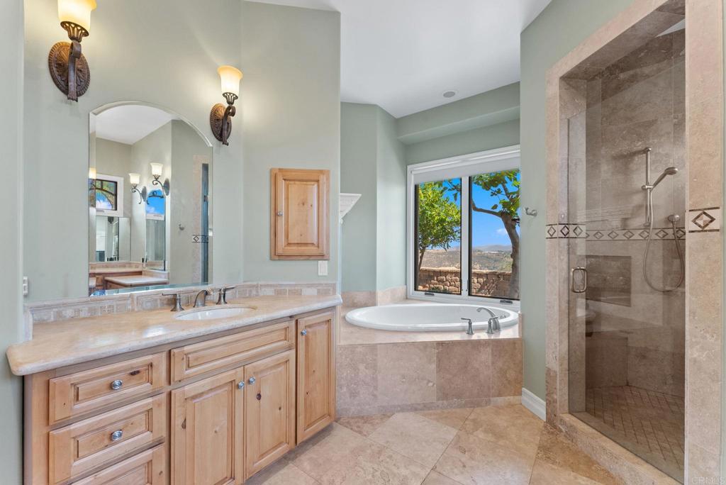 28820 Willow Park Road Escondido, CA 92026 - Photo 36 of 72 a bathroom with a double vanity sink a mirror and a shower
