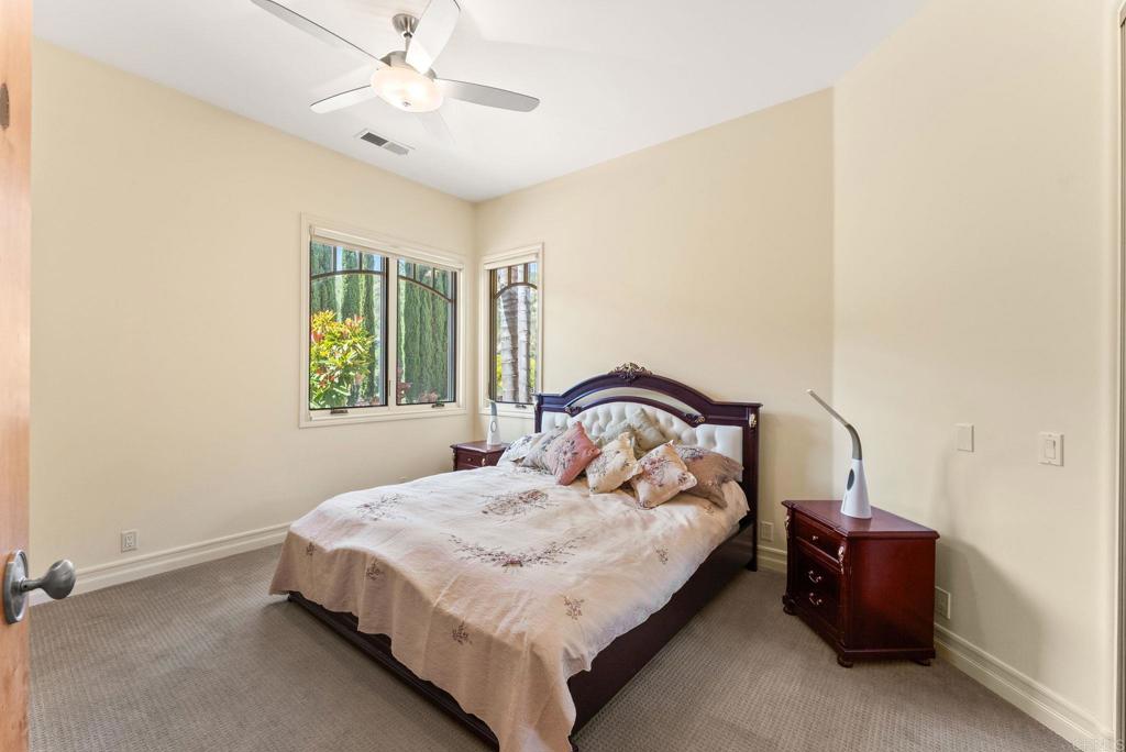 28820 Willow Park Road Escondido, CA 92026 - Photo 55 of 72 a bedroom with a bed and a chandelier