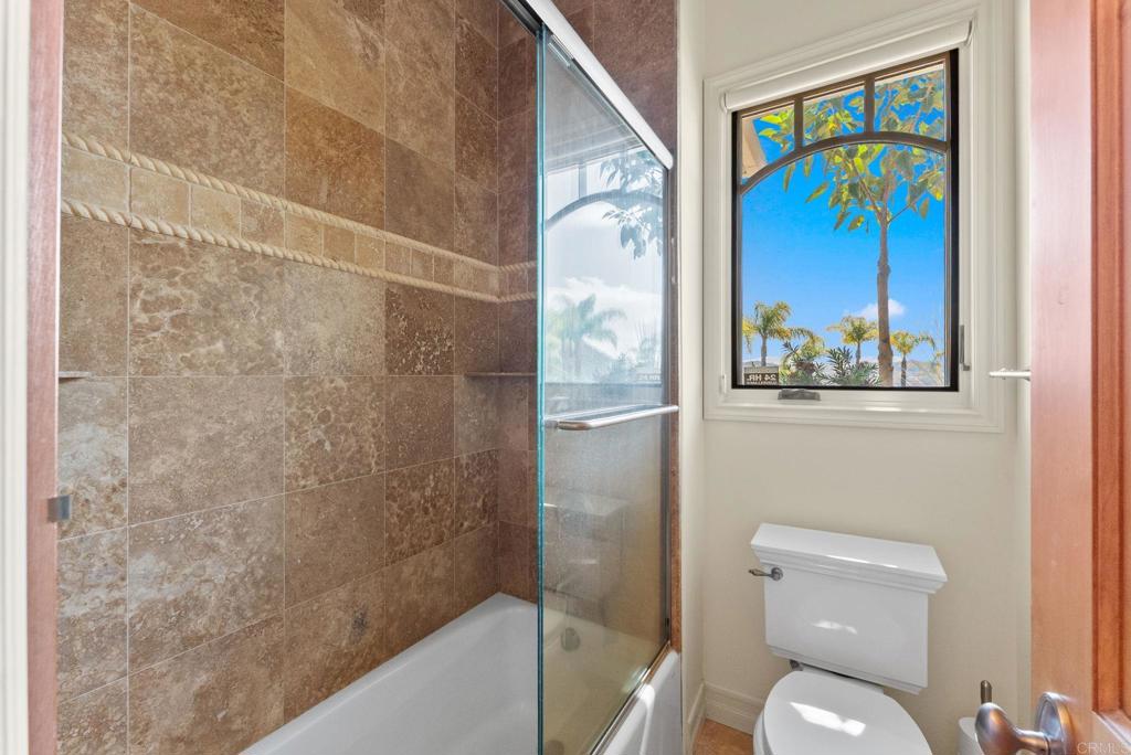28820 Willow Park Road Escondido, CA 92026 - Photo 58 of 72 a bathroom with a toilet and a painting on the wall