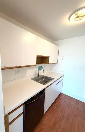a kitchen with a refrigerator stove and a window