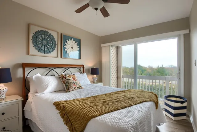 a bedroom with a large bed and a large window