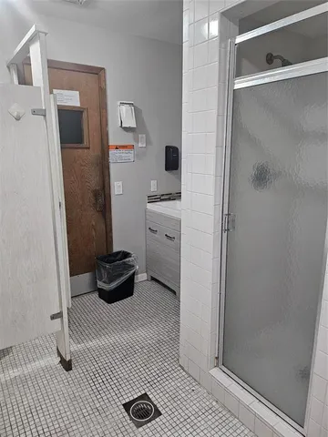 a kitchen with refrigerator and cabinets