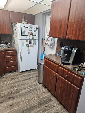 a workspace with furniture and a wooden floor