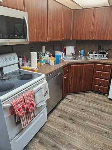 a bathroom with a granite countertop sink toilet and a mirror