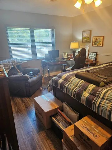 a bed sitting in a bedroom next to a window