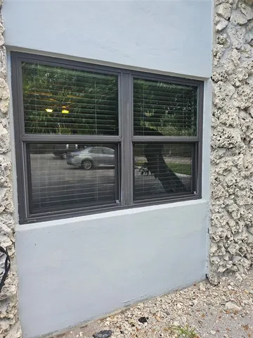 a view of entryway with a floor to ceiling window and wooden floor
