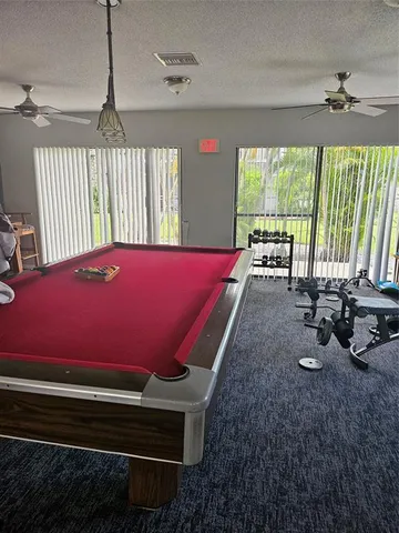 a living room with furniture and large windows