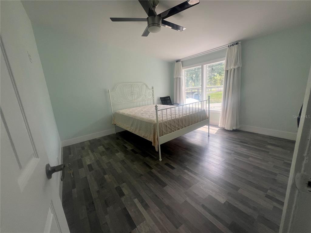 5855 Jack Brack Road St. Cloud, FL 34771 - Photo 74 of 86 a room with a bed and wooden floor