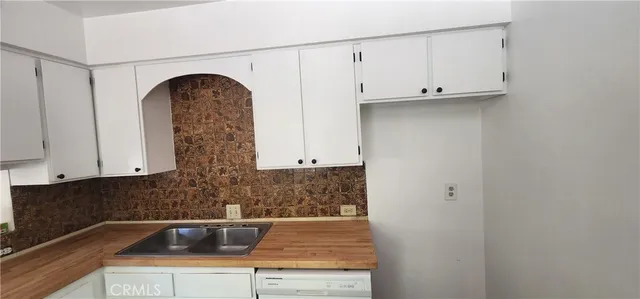 a view of kitchen with white cabinets