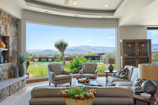 2331 West Entrada Trail, Unit 61 St. George, UT 84770 - Photo 10 of 69 Curved window wall showcasing a mountainous landscape and verdant grounds