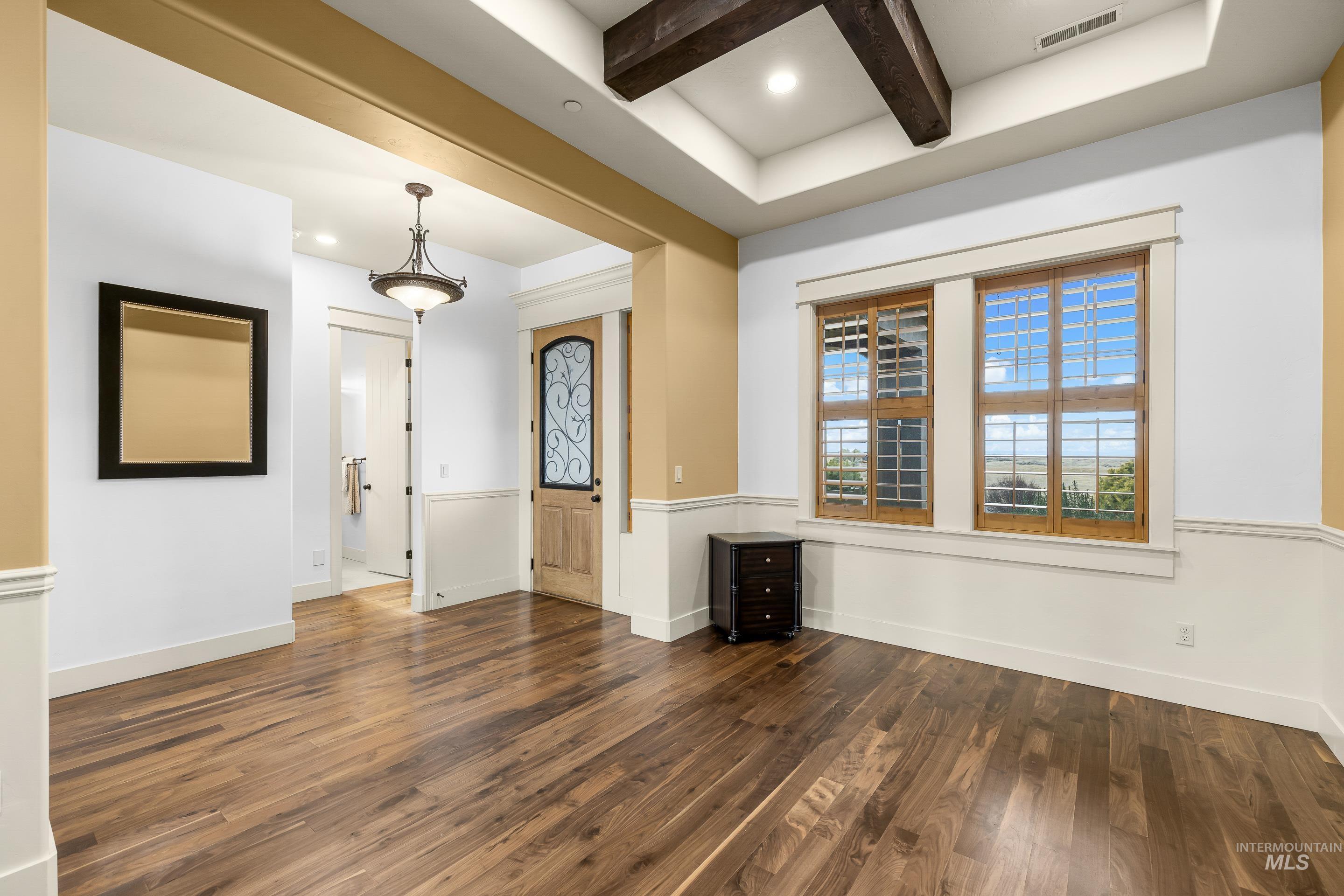 7521 North Grand Ridge Lane Eagle, ID 83616 - Photo 9 of 50 Empty room with beamed ceiling, dark wood-type flooring, and recessed lighting
