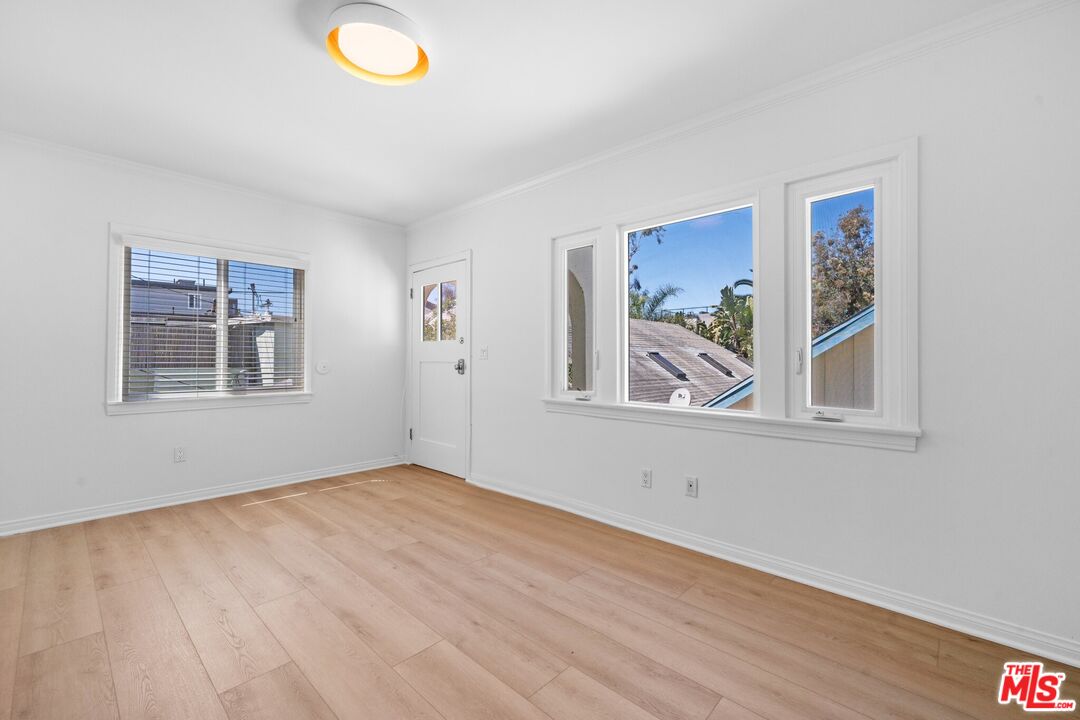 38 20th Avenue, Unit C Venice, CA 90291 - Photo 2 of 10 a view of an empty room with window and wooden floor