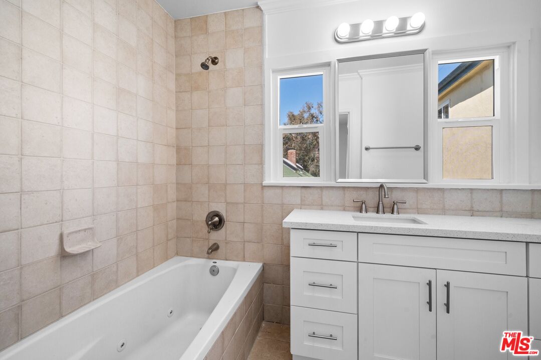 38 20th Avenue, Unit C Venice, CA 90291 - Photo 6 of 10 a bathroom with a granite countertop sink mirror toilet and bathtub
