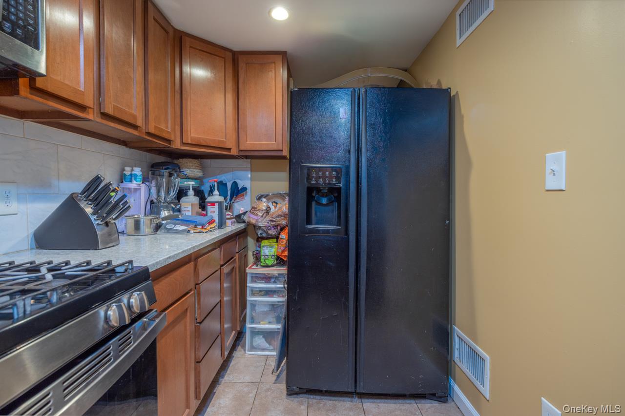 280 1st Street Newburgh, NY 12550 - Photo 12 of 24 a kitchen with stainless steel appliances granite countertop a refrigerator and a stove
