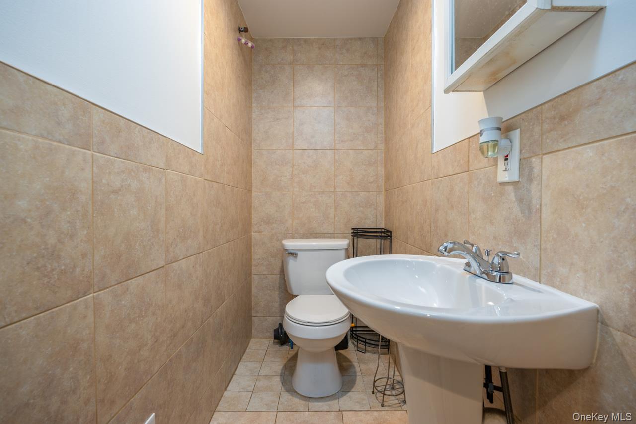 280 1st Street Newburgh, NY 12550 - Photo 13 of 24 a bathroom with a toilet and a sink