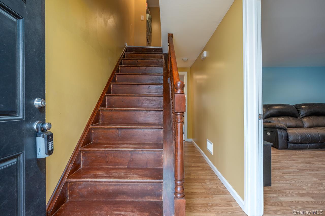 280 1st Street Newburgh, NY 12550 - Photo 15 of 24 a view of staircase with lots of frames on wall and windows