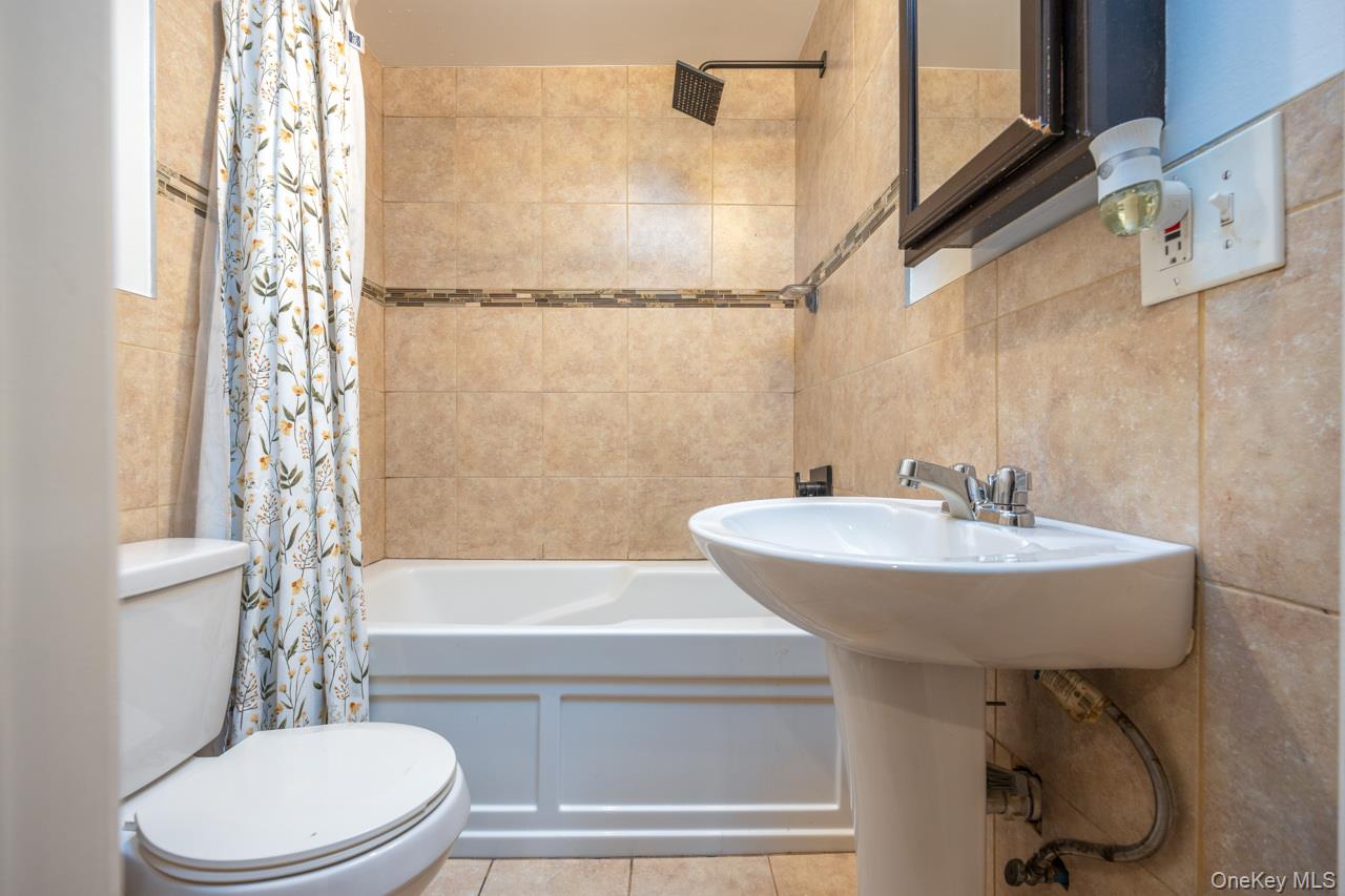 280 1st Street Newburgh, NY 12550 - Photo 16 of 24 a bathroom with a sink a toilet and bathtub