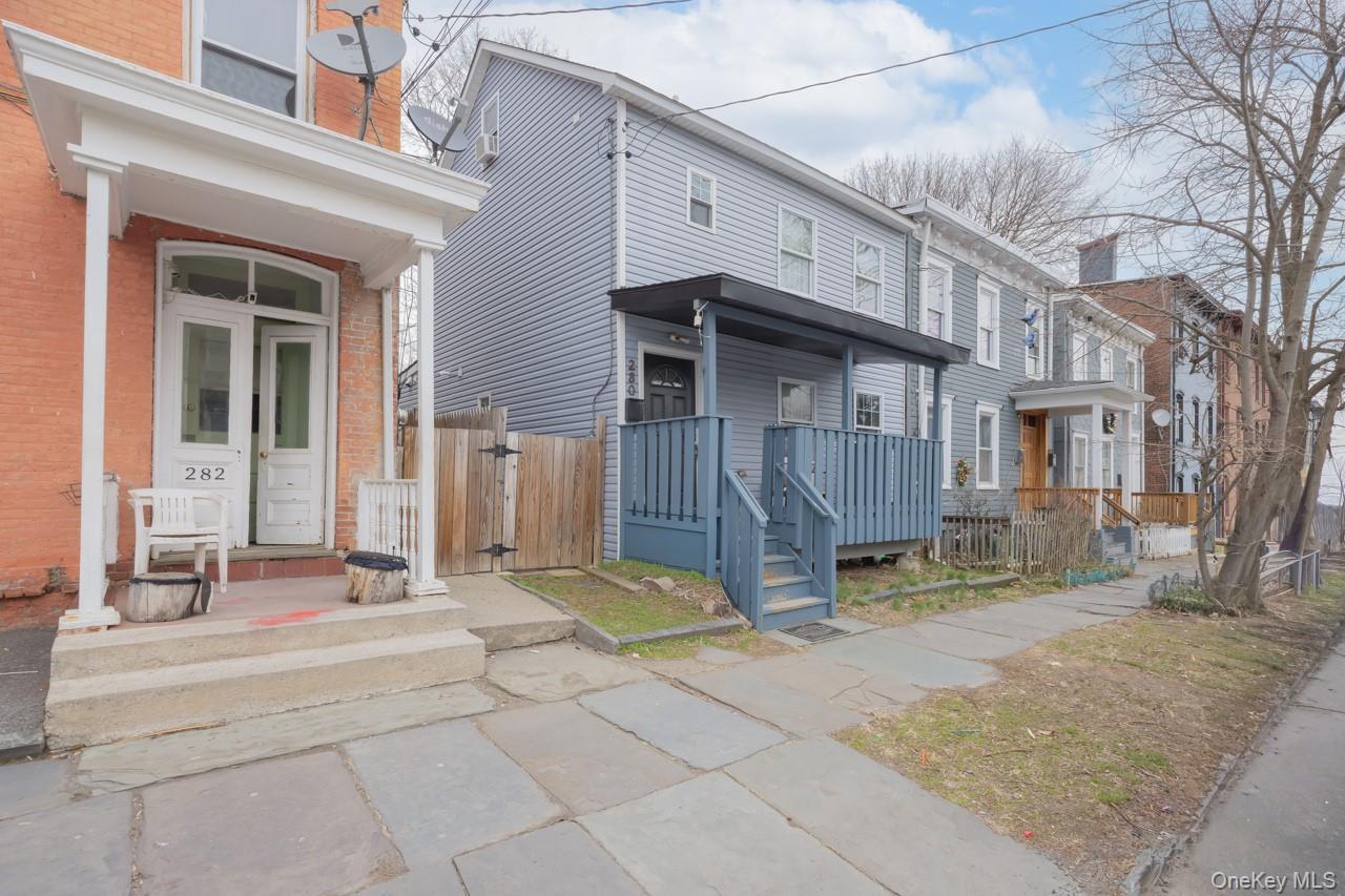 280 1st Street Newburgh, NY 12550 - Photo 2 of 24 a front view of a house with a yard outdoor seating and garage