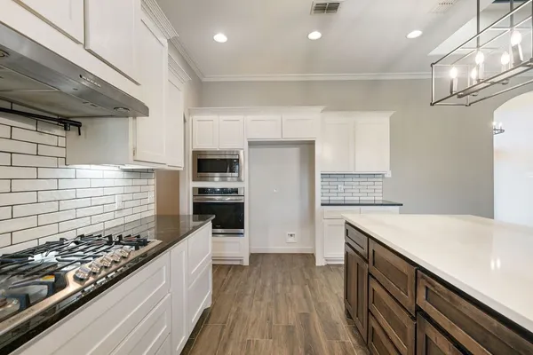 a kitchen with a stove and a refrigerator