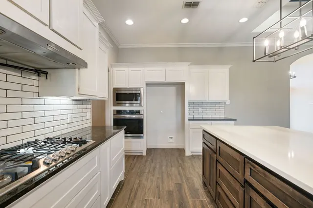 a kitchen with a stove and a refrigerator